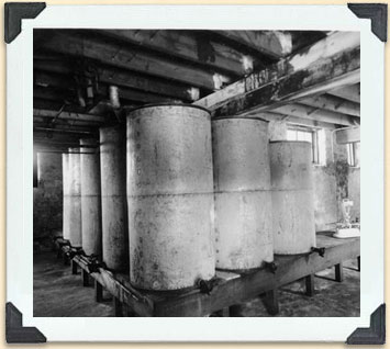 Each of these bulk tanks probably held a different type of honey, ca 1920. 