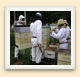 A mechanical lift powered by hydraulics helps these beekeepers handle heavy hive boxes full of honey.  
